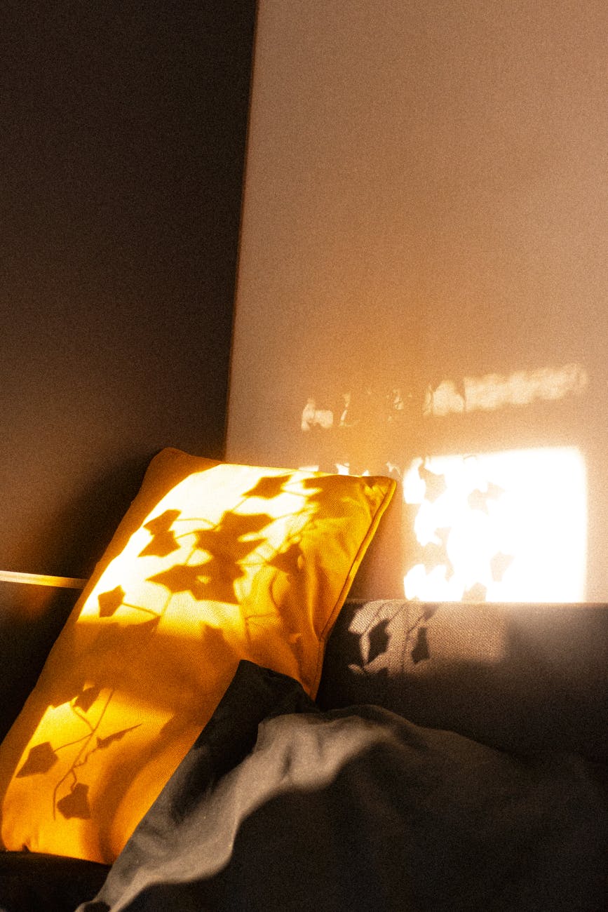 cozy bedroom with sunlit yellow cushion